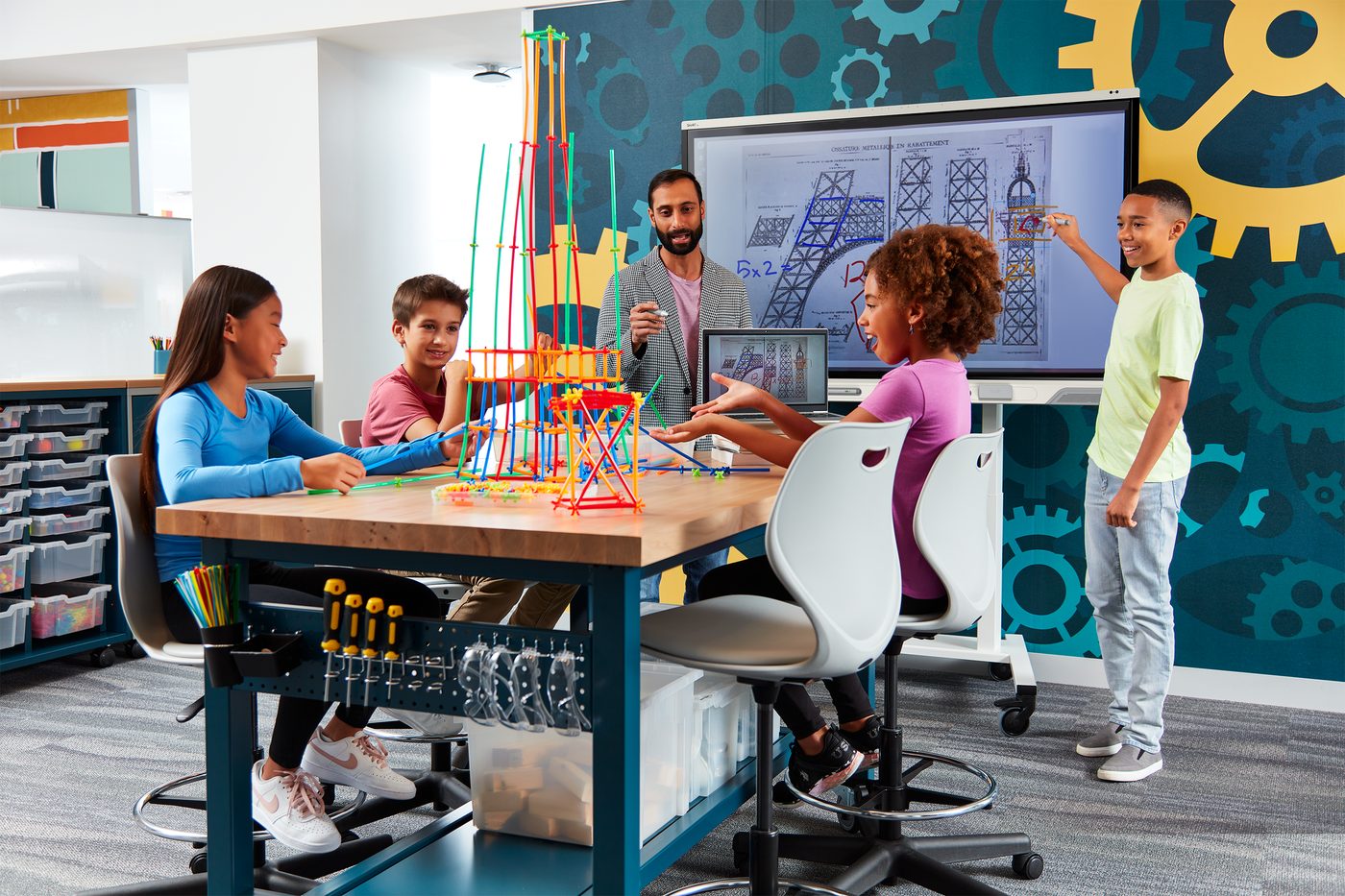 Students working together around a SMART Board display in a classroom